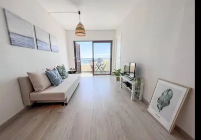 a living room with a couch and a television at Sea View One Bedroom with Swimming Pool Ponce 282 in Albufeira