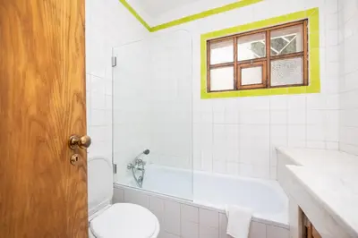a bathroom with a toilet and a sink and a tub at Villa Mexico in Quarteira