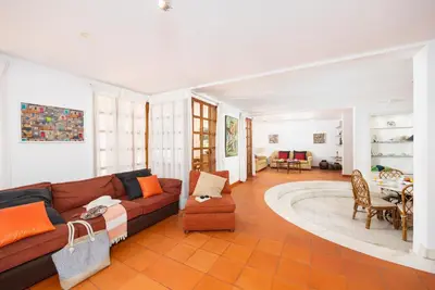a living room with a couch and a table at Villa Mexico in Quarteira