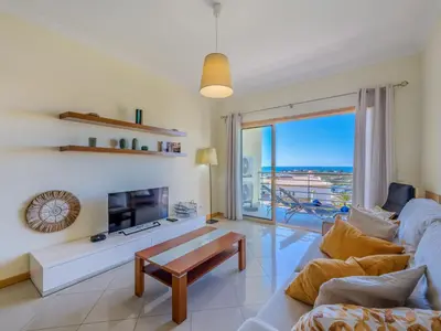 a bedroom with a bed and a chair and a window at Apartment Vista Mar by Interhome in Albufeira
