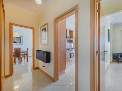 a living room with a white couch and a tv at Apartment Vista Mar by Interhome in Albufeira