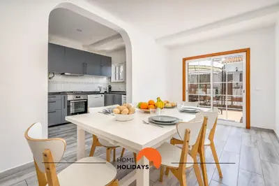 a white kitchen with a white table and chairs at #229 Quinta das Areias by Home Holidays in Albufeira