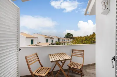 two chairs and a table on the balcony of a house at Oura Southvilla Algarve in Albufeira
