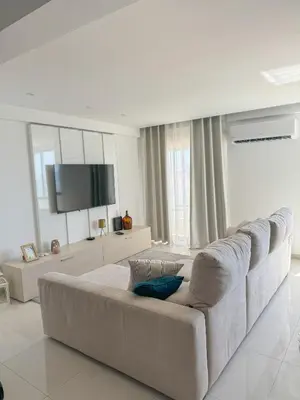a white living room with a large white couch at Riamar House - Faro City Center in Faro