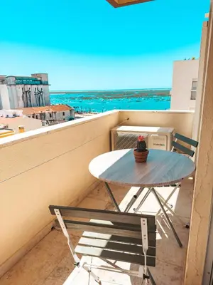 a white bathroom with a sink and a toilet at Riamar House - Faro City Center in Faro