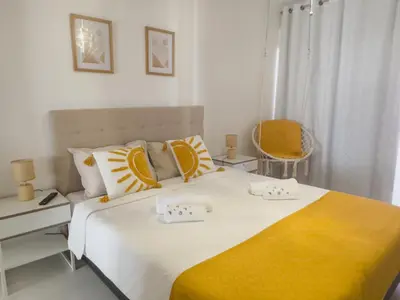 a white bathroom with a sink and a shower at Riamar House - Faro City Center in Faro