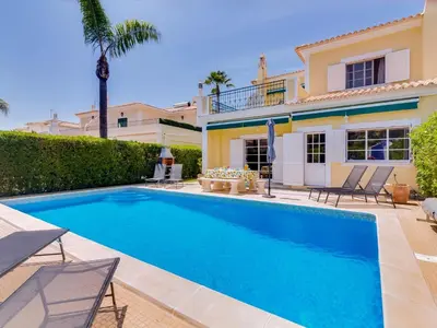 a swimming pool in the backyard of a house at AL Casa Raha in Quinta do Lago