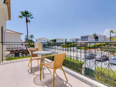 a patio with a table and chairs on a balcony at AL Casa Raha in Quinta do Lago