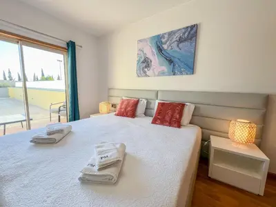 a bedroom with a bed with two towels on it at Fantastic Villa, Private Pool, BBQ, AC and Wi-Fi in Quarteira