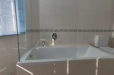 a white bath tub with a faucet in a bathroom at Private luxury apartment Vale do Lobo in Almancil