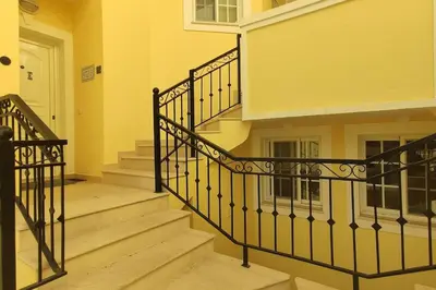 a staircase in a house with a black railing at Private luxury apartment Vale do Lobo in Almancil
