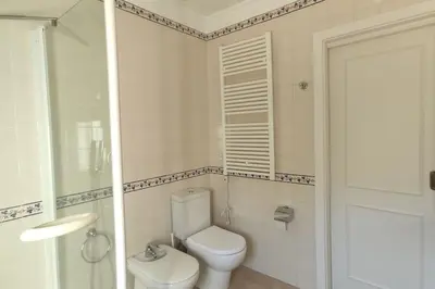 a white bathroom with a toilet and a shower at Private luxury apartment Vale do Lobo in Almancil