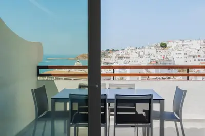 a table and chairs on a balcony with a view at MUPA Apartments in Albufeira