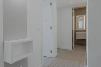 a room with white cabinets and a mirror at MUPA Apartments in Albufeira