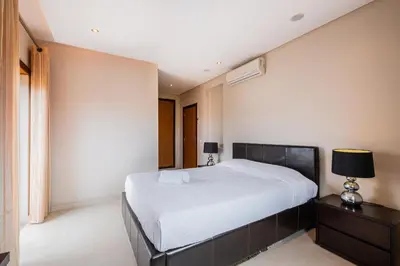 a bedroom with a large white bed and a nightstand at Capetown Marina Luxury Villa - Private Pool in Albufeira