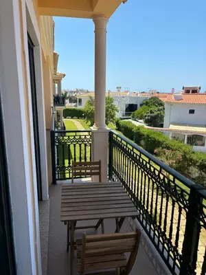 a balcony with two benches and a view of the city at Albufeira Appartement avec piscine in Albufeira