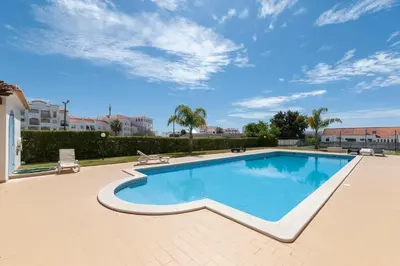 a swimming pool on a patio with a sky at Albufeira Appartement avec piscine in Albufeira