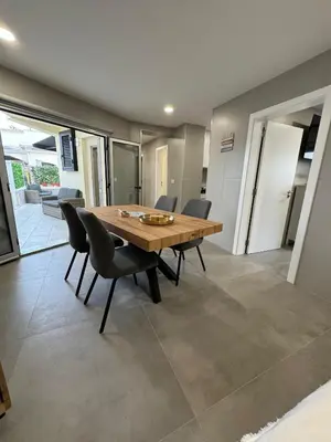 a dining room with a wooden table and chairs at Marina Gemeos - Vilamoura Center by HD Properties in Vilamoura