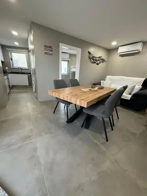 a dining room with a wooden table and chairs at Marina Gemeos - Vilamoura Center by HD Properties in Vilamoura