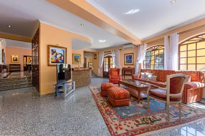a living room with couches and a tv in a room at Villa Sobreiro in Albufeira