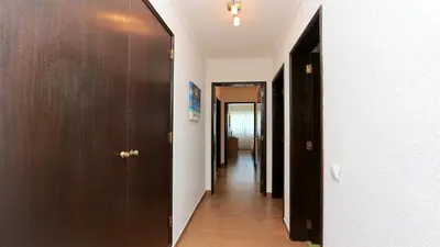 a hallway with two doors and a long corridor at Villa Lotus, CD 283 - Cleverdetails in Vilamoura