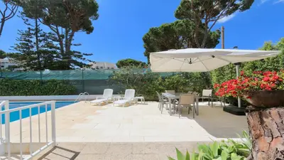 a patio with a table and an umbrella at Villa Lotus, CD 283 - Cleverdetails in Vilamoura