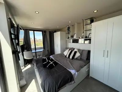 a bedroom with a bed and a large window at Vilamoura in Quarteira