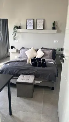 a bedroom with a bed with pillows and a table at Vilamoura in Quarteira