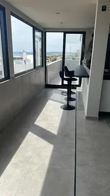 an office with a desk and chairs in a room with windows at Vilamoura in Quarteira