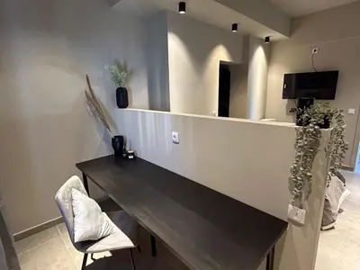 a dining room with a table and a television at Vilamoura in Quarteira