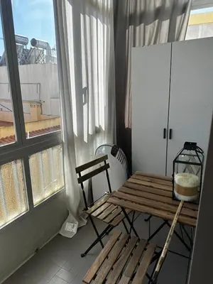 a balcony with a wooden bench and a window at Vilamoura in Quarteira