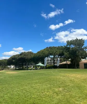 a green field with trees and a building in the background at Casa Joanna Vila Sol Golf Village in Quarteira