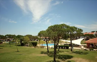 a park with a pool and trees and a building at Casa Joanna Vila Sol Golf Village in Quarteira
