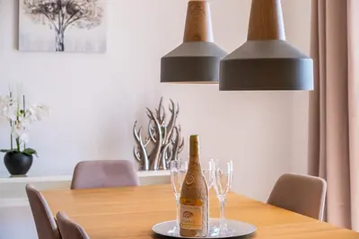 a bottle of champagne sitting on a table with glasses at Villa Gil in Albufeira