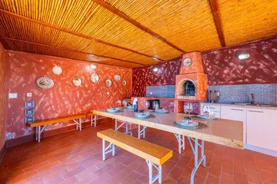 a kitchen with a long table and a stove at Orange Tree House in Albufeira