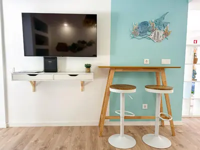 a pair of signs in front of a tree at BnB Homes Falésia Beach cozy Apartment with terrace & 2 Swimming Pools in Roja- Pé