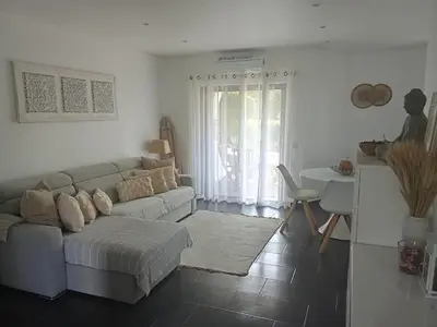 a living room with a couch and a table at ADO HOUSE Albufeira in Albufeira
