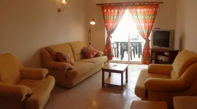 a living room with two couches and a tv at Apartamento Avenida da Liberdade in Albufeira