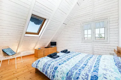 a bedroom with a bed and a chair in a attic at Villa Oliva - Maison 6 chambres in Vilamoura