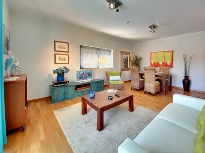 a living room with a couch and a table at Marina Sea Residence in Albufeira