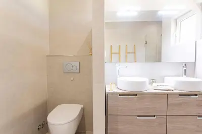 a bathroom with a toilet and a sink at Villa Matibora by HelloVacations in Albufeira