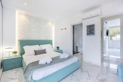a bedroom with a bed with two towels on it at Casa Verde Vilamoura in Quarteira