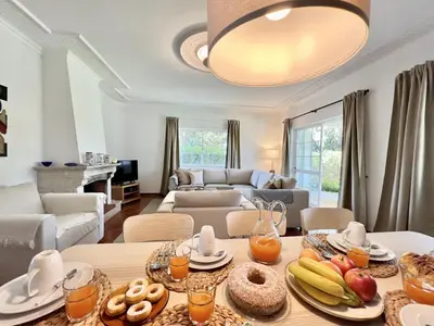 a living room with a table with food on it at Vilamoura White House Villa With Pool by Homing in Vilamoura