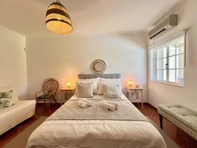 a bedroom with a large bed with two animal pillows on it at Vilamoura White House Villa With Pool by Homing in Vilamoura