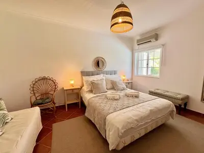 a bedroom with a large bed and a window at Vilamoura White House Villa With Pool by Homing in Vilamoura