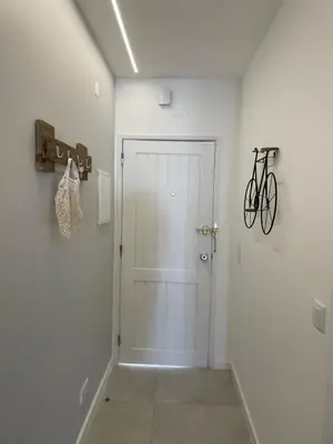 a hallway with a door and a bike on the wall at Modern Apartment with balcony and direct access to the pool in Albufeira