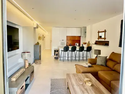 a living room with a couch and a table at Modern Apartment with balcony and direct access to the pool in Albufeira