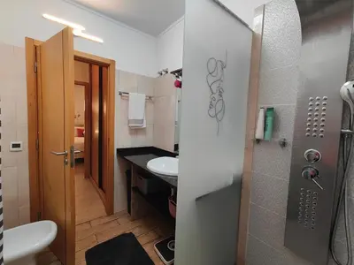two pictures of a bathroom with a sink and a toilet at Happy&Roses, Vilamoura, pool&golf in Vilamoura