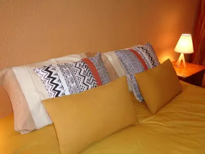 a bed with pillows on it in a bedroom at Apartamento Praia dos Salgados in Albufeira