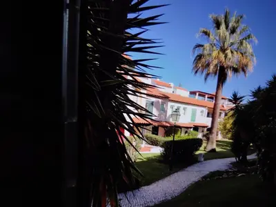 a living room with a couch and a fireplace at Nice flat in pretty condo in Quarteira